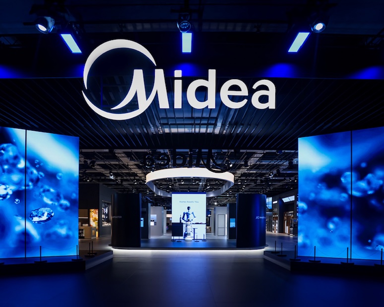 Front view of Midea exhibition booth at IFA 2025 by EIDETIC, showcasing illuminated LED panels, bold brand signage, and a structured spatial entrance design