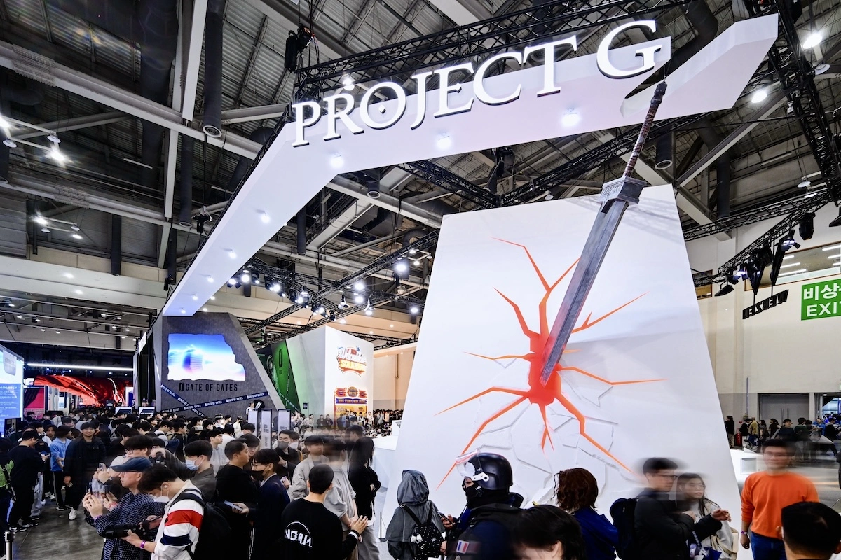 Crowds gathering at Webzen Project G booth featuring oversized greatsword sculpture at G-Star Korea