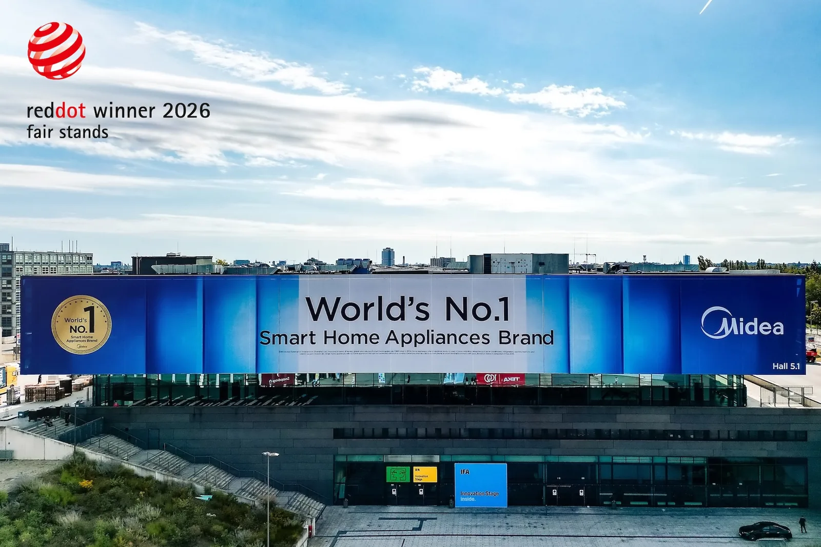 Red Dot Award 2026 Fair Stands winner badge with Midea's IFA 2025 exhibition branding at Messe Berlin, by EIDETIC