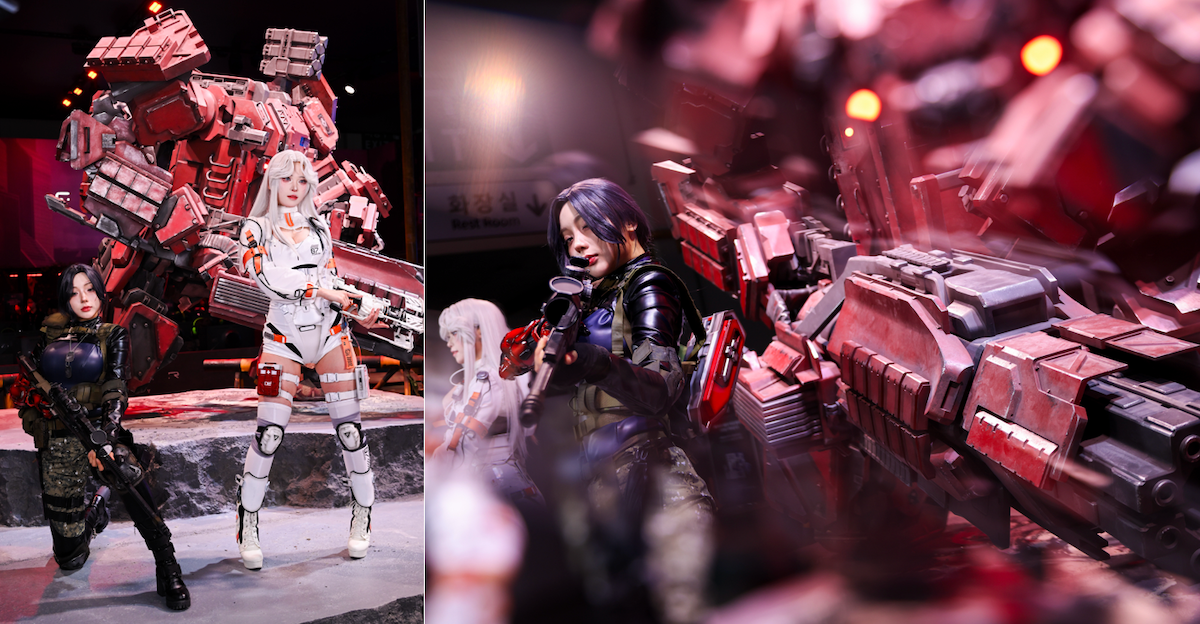 Cinder City: Cosplayers posing with a large red mech installation at a game exhibition booth.